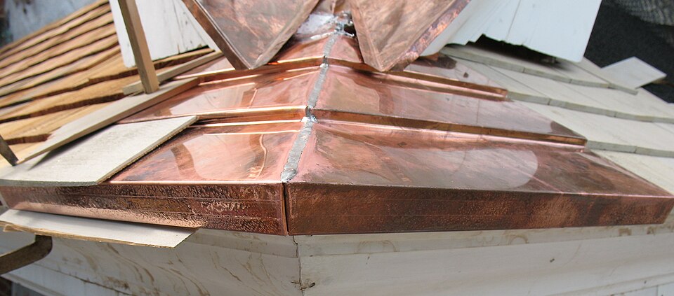 Copper valley flashing with formed and soldered joints between roof slopes