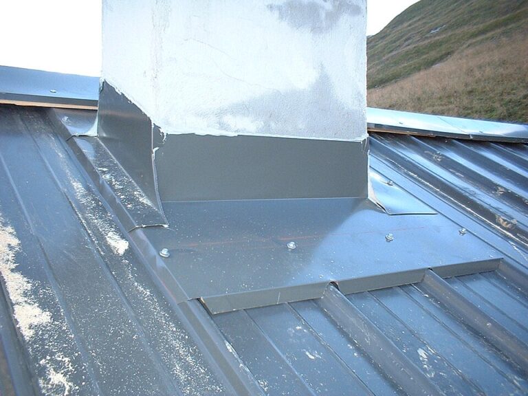 Metal apron and side flashing around a chimney on corrugated roof sheets